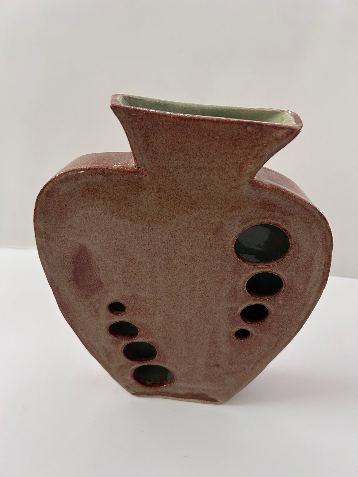 Earthy Ceramic Vase with Circular Cutouts